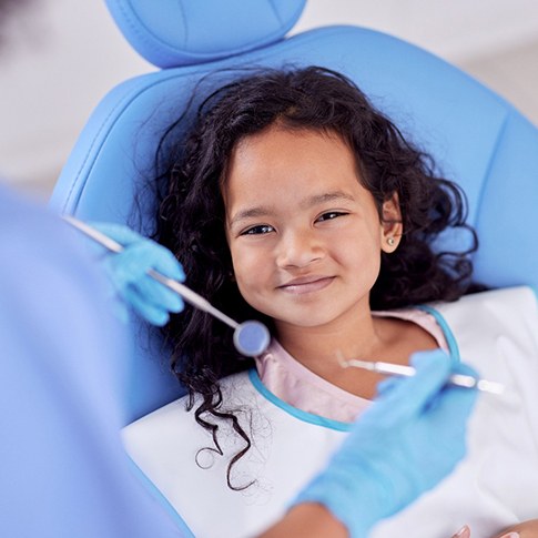 Child smiling during dental checkup