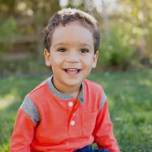 Young child outdoors smiling