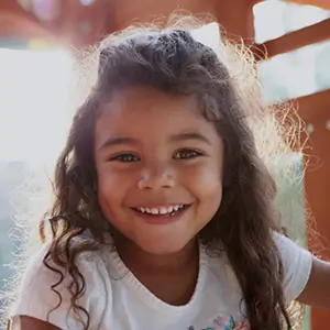 Young girl smiling outdoors