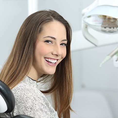 a teen at the dentist smiling