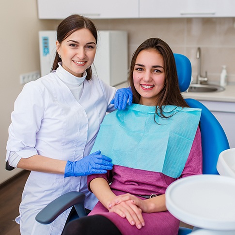 a teen and her dentist smiling