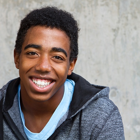 a closeup of a teen smiling