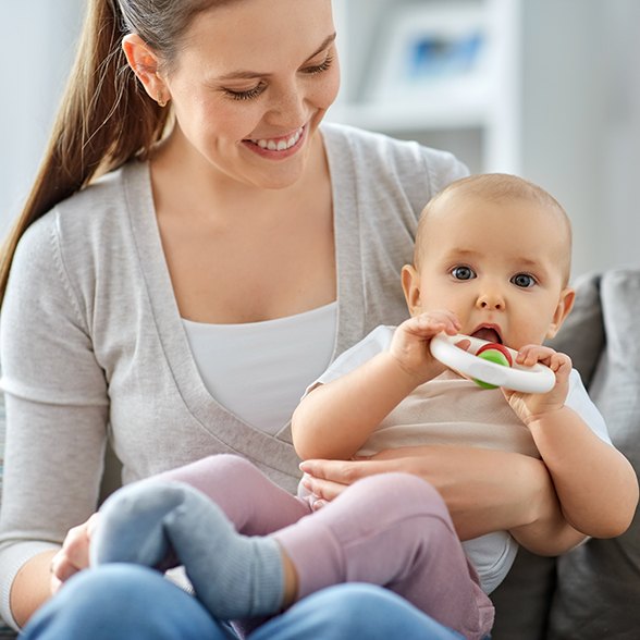 Mother holding her baby during the teething phase in Worcester