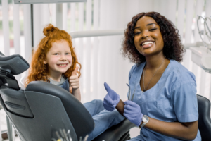 a child smiling at their dentist