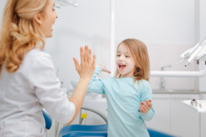 a child smiling at their dentist